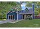 Charming two-story home with blue siding, a welcoming porch, and landscaped front yard at 8007 Maxwelton Dr, Huntersville, NC 28078