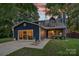 Charming two-story home with blue siding, a welcoming porch, and a well lit front window at 8007 Maxwelton Dr, Huntersville, NC 28078