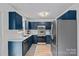 Well-equipped kitchen featuring blue cabinets, stainless steel appliances, and ample counter space at 8007 Maxwelton Dr, Huntersville, NC 28078