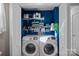 Convenient laundry room with modern washer and dryer units, shelving for storage, and easy access at 8007 Maxwelton Dr, Huntersville, NC 28078