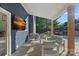 Covered patio with a large TV, comfortable seating, and view of the pool at 8007 Maxwelton Dr, Huntersville, NC 28078