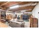 Unfinished basement area showcasing exposed ceiling, a wood burning stove, and ample storage space at 95 Odell Ct, Taylorsville, NC 28681