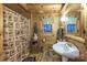 The wooden bathroom features a shower-tub combination, sink, toilet, and a window with a view at 95 Odell Ct, Taylorsville, NC 28681