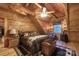 Cozy wooden bedroom featuring a ceiling fan, window, decorative lanterns and a wood burning stove at 95 Odell Ct, Taylorsville, NC 28681
