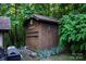 View of shed with ladder, outdoor lighting, and lush foliage at 95 Odell Ct, Taylorsville, NC 28681