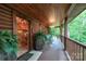 Spacious porch featuring wood floors, rocking chairs, lanterns, a staircase, and lush surroundings at 95 Odell Ct, Taylorsville, NC 28681