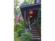 Covered porch with traditional furniture, including rocking chairs and an American flag at 95 Odell Ct, Taylorsville, NC 28681