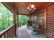Relaxing covered porch featuring a bench and peaceful wooded view, perfect for unwinding at 95 Odell Ct, Taylorsville, NC 28681