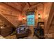 This is a cozy wood-paneled reading nook, featuring a cow print chair, small wood-burning stove, and a window at 95 Odell Ct, Taylorsville, NC 28681