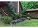 Exterior view of a charming log home with lush landscaping, steps, and an adjacent log cabin at 95 Odell Ct, Taylorsville, NC 28681