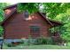Side exterior view of a log home featuring steps, and natural landscaping at 95 Odell Ct, Taylorsville, NC 28681