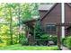 Side view of a log cabin featuring lush landscaping, a small dog house and an American flag at 95 Odell Ct, Taylorsville, NC 28681