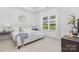 Bright bedroom featuring a tray ceiling, a large window, and neutral decor at 102 W Georgia Ave, Bessemer City, NC 28016