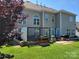 Rear exterior view featuring a stone patio and privacy screening at 103 Doyle Farm Ln, Mooresville, NC 28115