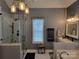 Bright bathroom features double sinks, soaking tub, separate glass-enclosed shower, and elegant fixtures at 103 Doyle Farm Ln, Mooresville, NC 28115