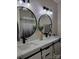 Modern bathroom featuring double sinks with black fixtures and round mirrors at 103 Doyle Farm Ln, Mooresville, NC 28115