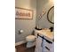 Stylish half bathroom with modern fixtures and beach-themed decor at 103 Doyle Farm Ln, Mooresville, NC 28115