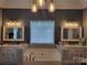Luxurious soaking tub between two vanities in a spacious bathroom at 103 Doyle Farm Ln, Mooresville, NC 28115
