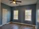 Clean bedroom with two windows, light gray walls and hardwood floors at 103 Doyle Farm Ln, Mooresville, NC 28115