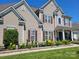 Close-up of a well-maintained exterior featuring manicured flower beds and healthy green bushes at 103 Doyle Farm Ln, Mooresville, NC 28115