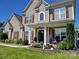 Charming two-story home with well-maintained landscaping, shutters, and a welcoming front entrance at 103 Doyle Farm Ln, Mooresville, NC 28115