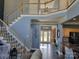 Bright foyer with staircase, chandelier, hardwood floors, and elegant decor welcomes you home at 103 Doyle Farm Ln, Mooresville, NC 28115