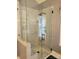 Spacious glass shower boasts marble-style walls, a rainfall shower head, and built-in seating at 103 Doyle Farm Ln, Mooresville, NC 28115