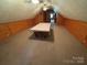 Unfinished attic with wood paneling and a carpeted floor, offering potential for customization at 103 Duke St, Great Falls, SC 29055