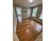 Bedroom with hardwood floors, three windows, and natural light at 103 Duke St, Great Falls, SC 29055