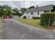 Long paved driveway leading to a house with garages, providing ample parking at 103 Duke St, Great Falls, SC 29055