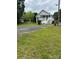 Charming home with covered front porch, inviting curb appeal, and expansive front yard at 103 Duke St, Great Falls, SC 29055