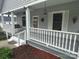 Charming front porch with swing, white railing, gray floor, and stylish decor at 103 Duke St, Great Falls, SC 29055