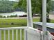 View of the lake from the porch of a property with railings at 103 Duke St, Great Falls, SC 29055