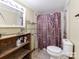 Bathroom features tile floors, a shower with curtain, vanity with lighting and shelving for storage at 106 Deaver St, Chester, SC 29706