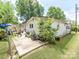 Exterior view of home featuring a patio area, lush landscaping, and mature trees at 106 Deaver St, Chester, SC 29706