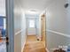 Narrow hallway featuring hardwood floors and neutral wall colors at 106 Deaver St, Chester, SC 29706