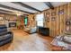 Spacious living room with wood-paneled walls, wood floors, and a fireplace at 106 Deaver St, Chester, SC 29706