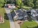 Aerial view of the property showcasing the home, spacious backyard, shed, and extended driveway at 107 Pressley St, Clover, SC 29710