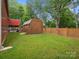 Well-maintained backyard featuring a shed, fenced-in yard, and lush green grass at 107 Pressley St, Clover, SC 29710
