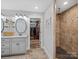 Bathroom showcasing double vanity, tiled shower, and convenient access to a walk-in closet at 107 Pressley St, Clover, SC 29710