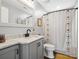 Well-lit bathroom featuring a vanity with drawers and a full shower with a decorative curtain at 107 Pressley St, Clover, SC 29710