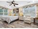 Calm bedroom with large windows, ceiling fan, and a comfortable seating area at 107 Pressley St, Clover, SC 29710