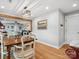 Dining area featuring hardwood floors and seamless flow into the adjacent living room at 107 Pressley St, Clover, SC 29710