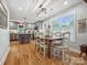 Bright dining area with large windows, stylish lighting, and adjacent island kitchen at 107 Pressley St, Clover, SC 29710