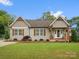 Charming single-story home features wood accents, shutters, and a well-manicured front yard at 107 Pressley St, Clover, SC 29710