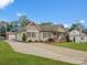 Well-kept single story home with a long concrete driveway and lush, green lawn at 107 Pressley St, Clover, SC 29710