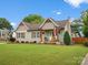 Charming bungalow style home with green grass and a small, manicured tree at 107 Pressley St, Clover, SC 29710