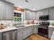 Close-up of a kitchen featuring stainless appliances, gray cabinetry, and marble countertops at 107 Pressley St, Clover, SC 29710