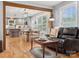 Open living space connects to the kitchen with hardwood floors and a neutral color scheme at 107 Pressley St, Clover, SC 29710