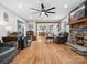 Inviting living room featuring hardwood floors, stone fireplace, and open access to the kitchen at 107 Pressley St, Clover, SC 29710